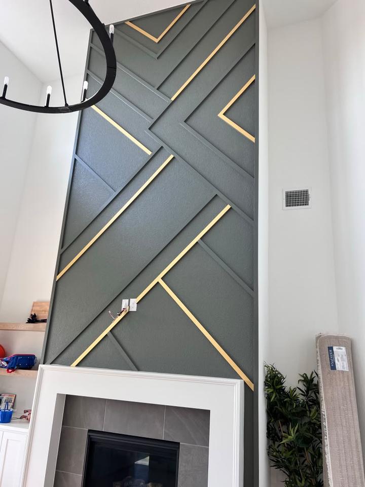 Charcoal paneled wall with brass inlay lines