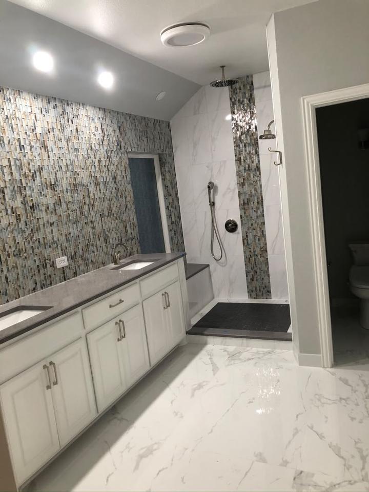 Marble bathroom with mosaic feature wall