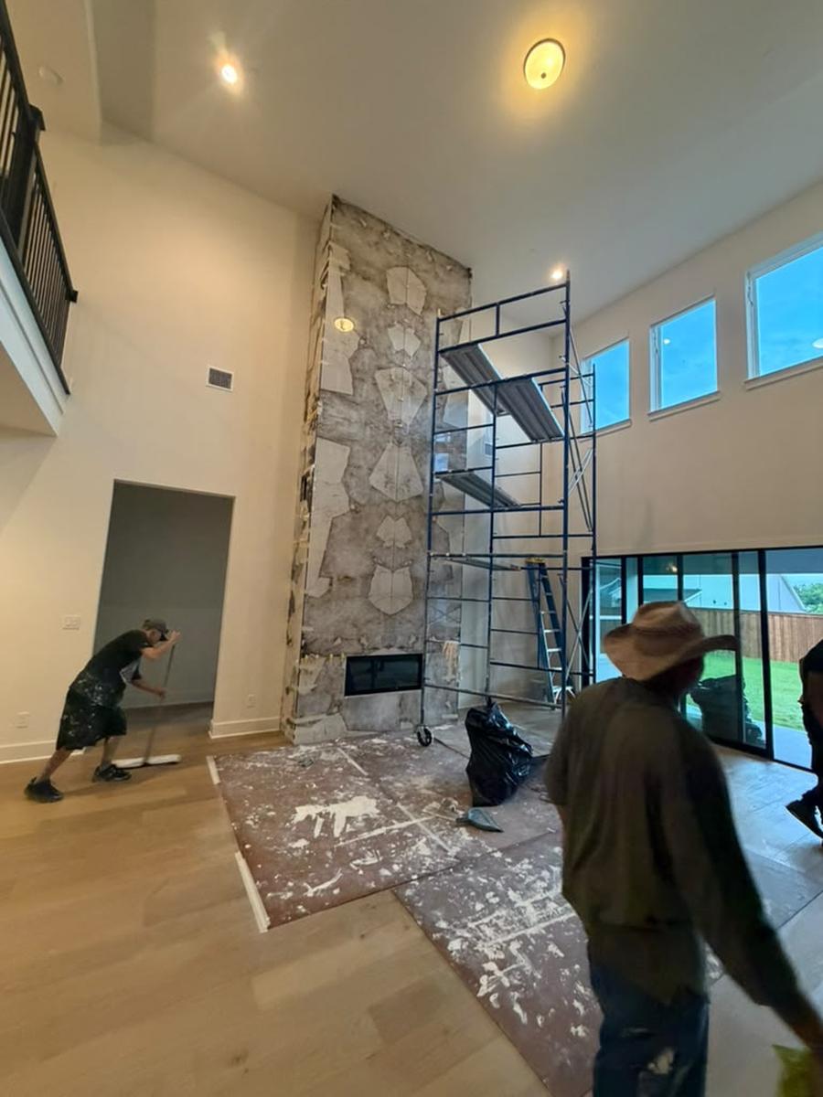 Crew setting large stone-look tiles on the chase